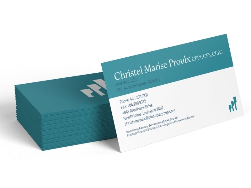 Teal and white business card front with the name Christel Marise Proulx and contact details, fanned over a stack of cards in the background.