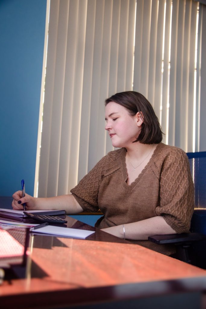 Abby writing notes at her desk
