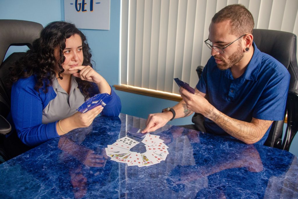 Mailstar designers playing cards with a Mailstar-branded deck