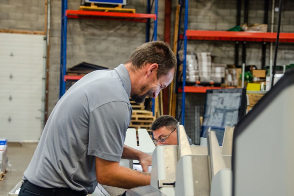 Mailstar production team member loading an inserting machine