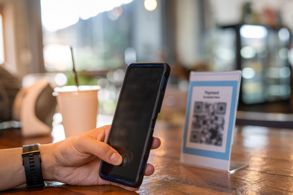 Person scanning QR code on placard